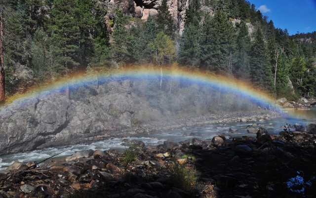 a rainbow effect from the steam and river